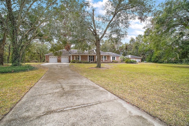 ranch-style house featuring a garage and a front lawn