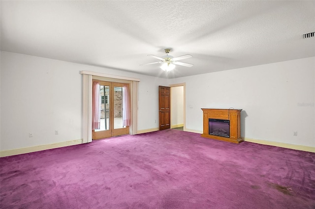 unfurnished living room with a textured ceiling, carpet floors, and ceiling fan