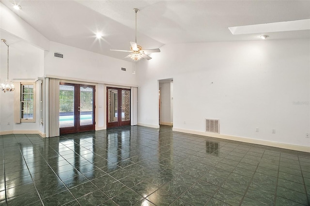 spare room with ceiling fan, french doors, and high vaulted ceiling