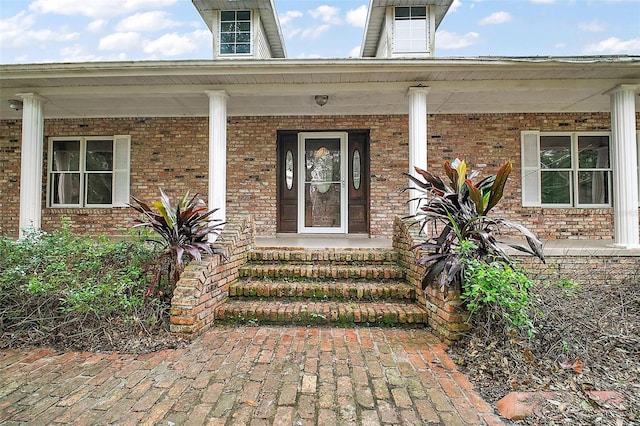 view of exterior entry with covered porch