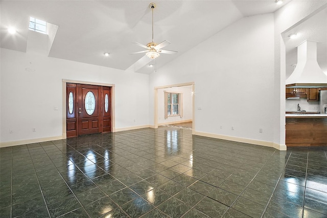 foyer featuring ceiling fan and high vaulted ceiling