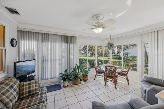 sunroom featuring ceiling fan