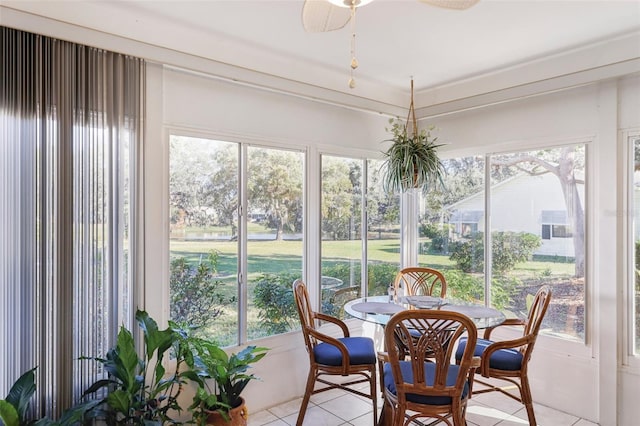 sunroom featuring ceiling fan and a healthy amount of sunlight