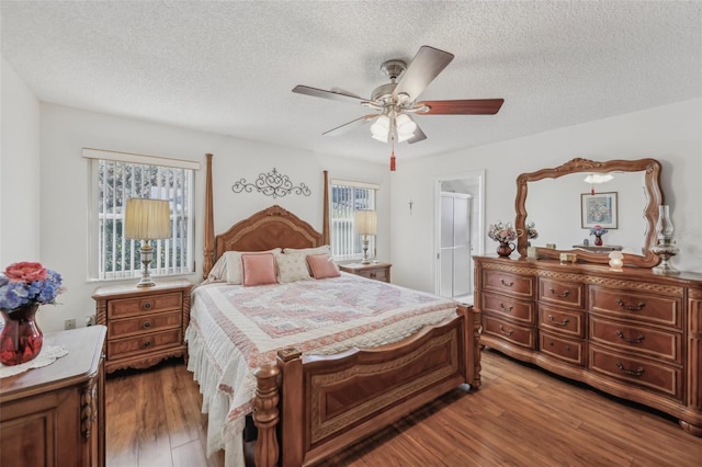 bedroom featuring a textured ceiling, hardwood / wood-style flooring, and ceiling fan