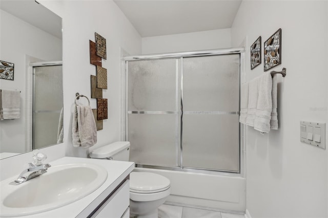 full bathroom featuring vanity, enclosed tub / shower combo, and toilet