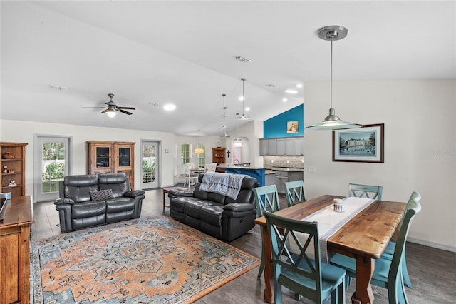 interior space with ceiling fan, a wealth of natural light, wood-type flooring, and vaulted ceiling