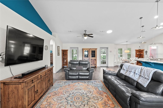 living room with vaulted ceiling, ceiling fan, hardwood / wood-style flooring, and sink