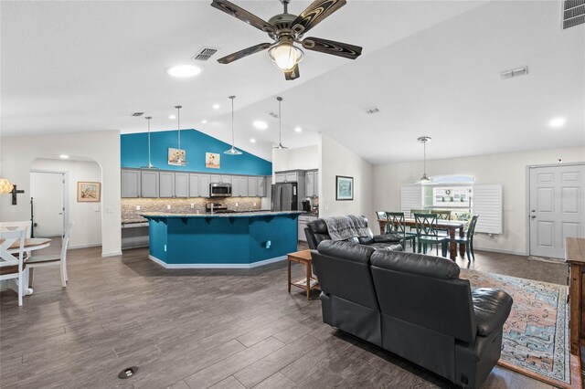 living room featuring ceiling fan, dark hardwood / wood-style flooring, and lofted ceiling