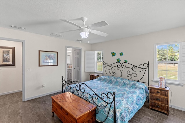 bedroom with ceiling fan, multiple windows, and hardwood / wood-style floors