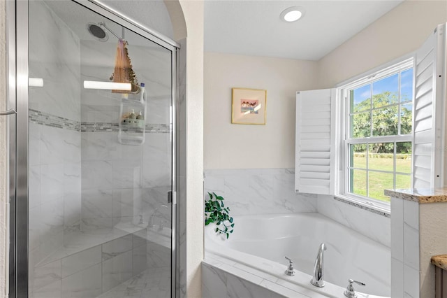 bathroom featuring independent shower and bath