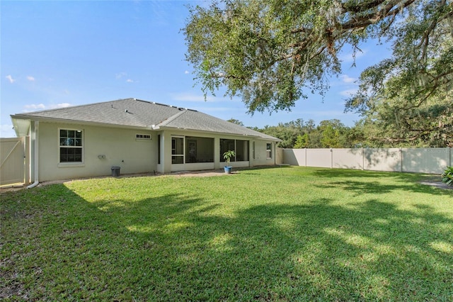 back of house with a lawn