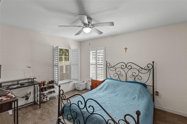 bedroom featuring ceiling fan and dark hardwood / wood-style flooring