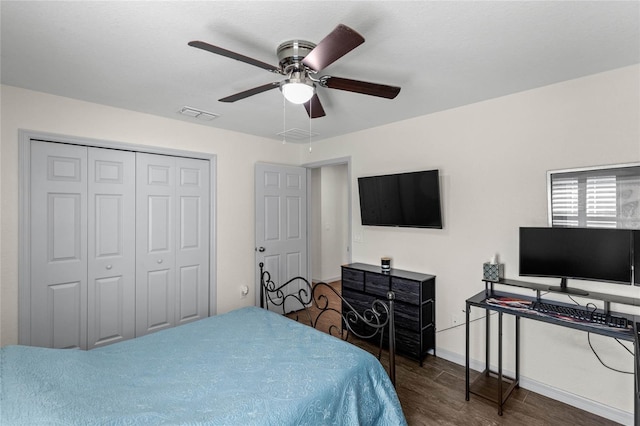 bedroom with ceiling fan, dark hardwood / wood-style flooring, and a closet