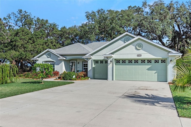 ranch-style home with a garage and a front lawn