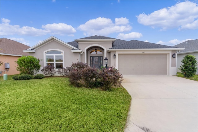 view of front of property with a garage and a front yard