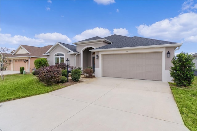 view of front of property featuring a garage and a front lawn