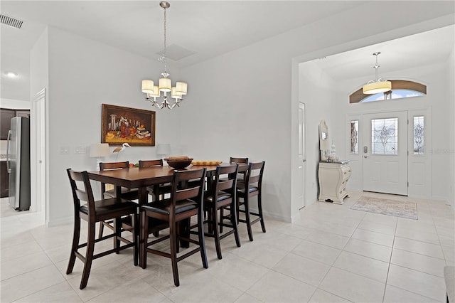 dining room featuring light tile patterned floors and a chandelier