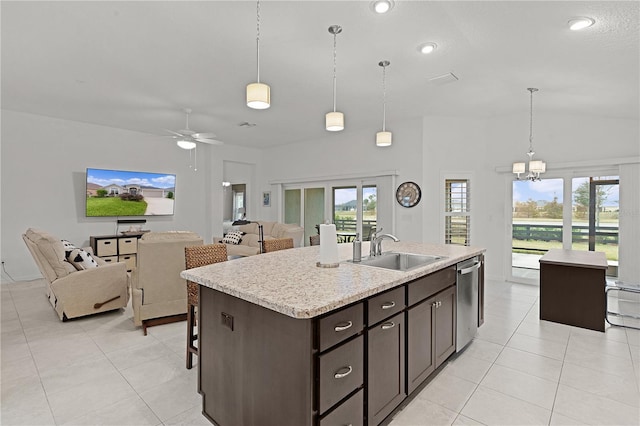 kitchen with dishwasher, a kitchen island with sink, sink, hanging light fixtures, and dark brown cabinetry