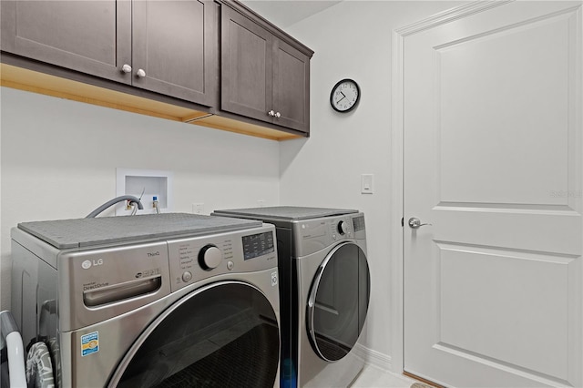 laundry area featuring washer and dryer and cabinets