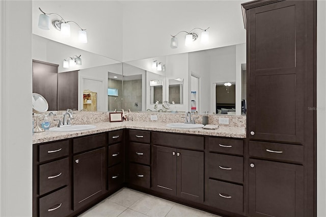 bathroom with tile patterned floors, vanity, and walk in shower