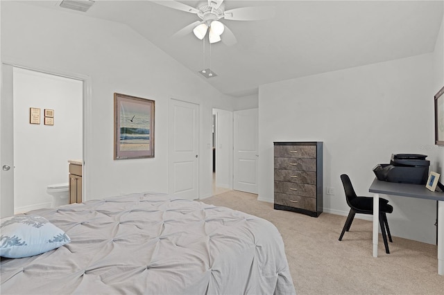 carpeted bedroom featuring ensuite bathroom, vaulted ceiling, and ceiling fan