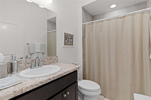 bathroom with a shower with curtain, vanity, and toilet