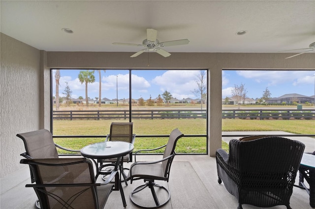 sunroom featuring ceiling fan and a healthy amount of sunlight