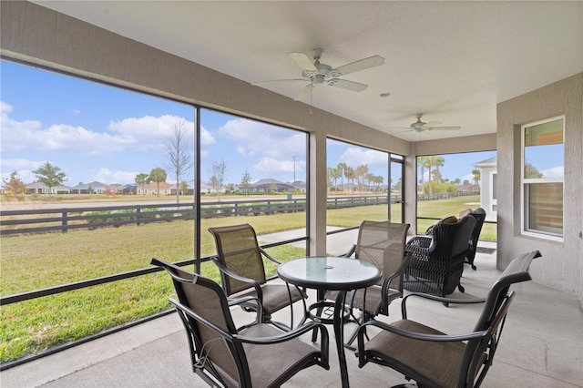 sunroom / solarium featuring ceiling fan