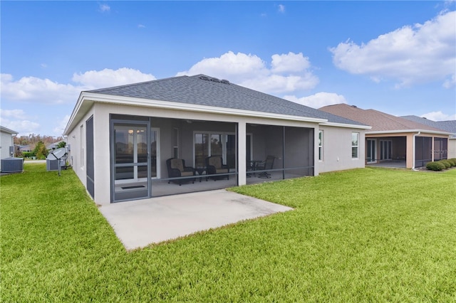 back of property with a sunroom, cooling unit, and a yard