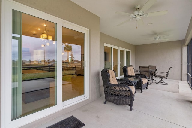 patio terrace at dusk featuring ceiling fan