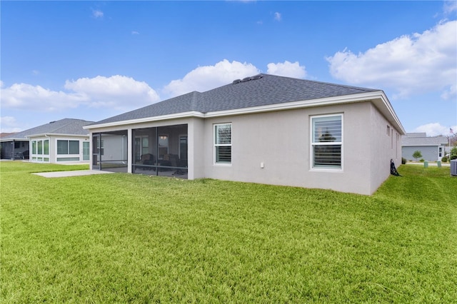 back of house with a sunroom and a yard