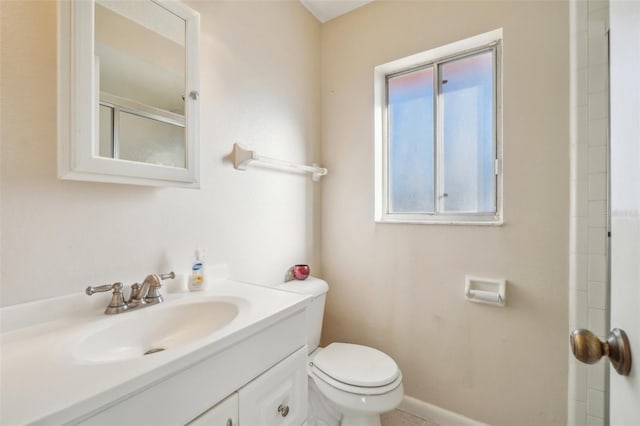 full bath with toilet, baseboards, a shower, and vanity