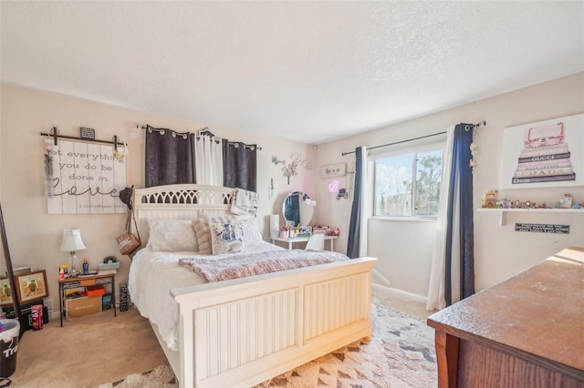 bedroom with a textured ceiling and light colored carpet