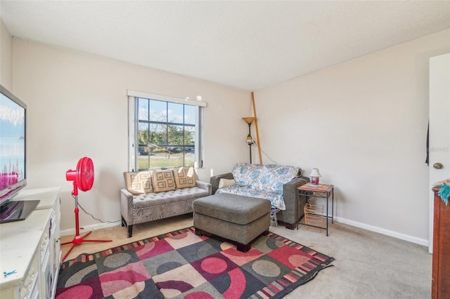 living room featuring carpet flooring and baseboards