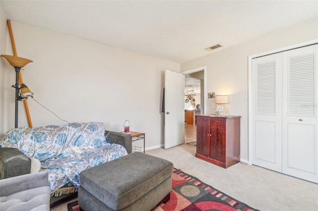 living room featuring baseboards, visible vents, and light colored carpet