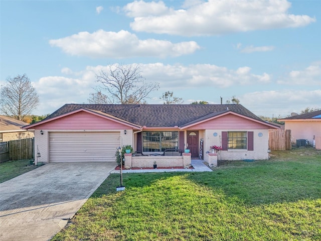 single story home featuring concrete driveway, brick siding, fence, and a front lawn