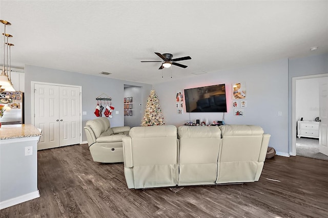 living room with ceiling fan and dark hardwood / wood-style floors