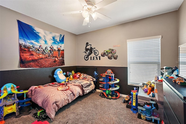 bedroom featuring ceiling fan and carpet