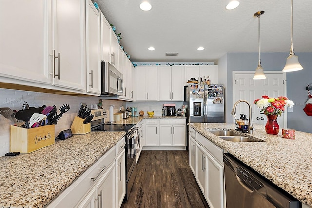 kitchen featuring tasteful backsplash, white cabinetry, appliances with stainless steel finishes, and sink