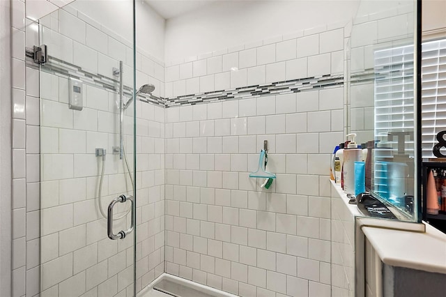 bathroom with a shower with door