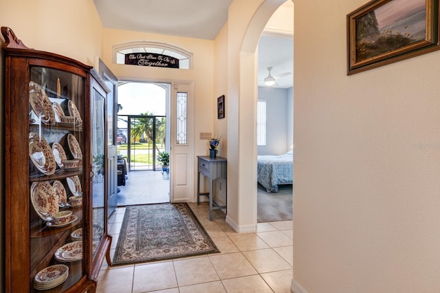 entryway with ceiling fan and light tile patterned floors