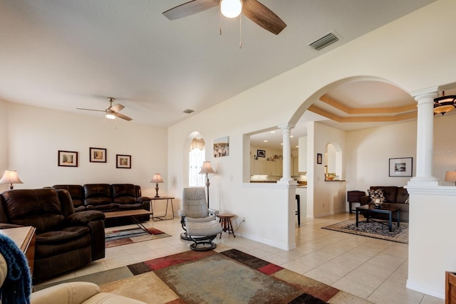 living room with ceiling fan, light tile patterned floors, and decorative columns