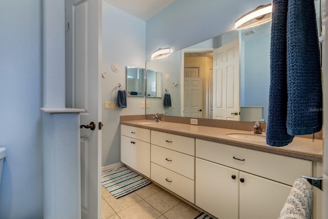 bathroom featuring tile patterned flooring and vanity