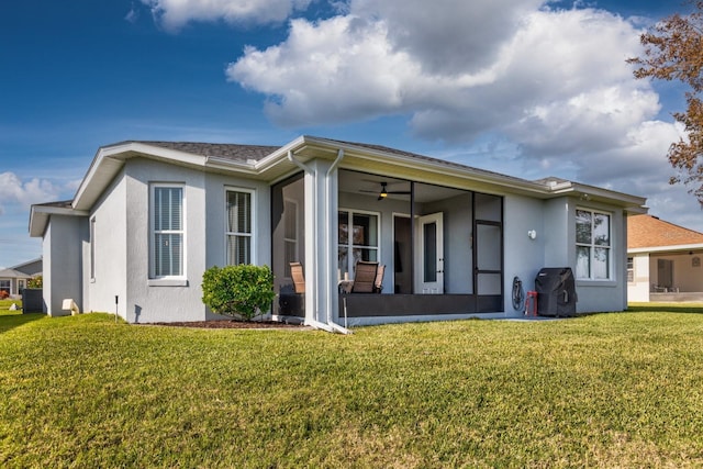 rear view of property with a yard, cooling unit, and a sunroom