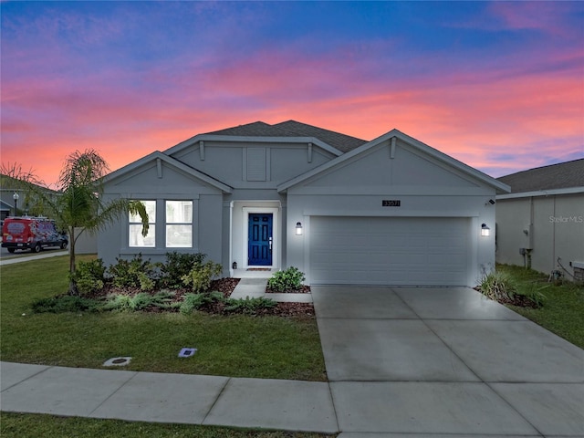 view of front of home featuring a lawn and a garage