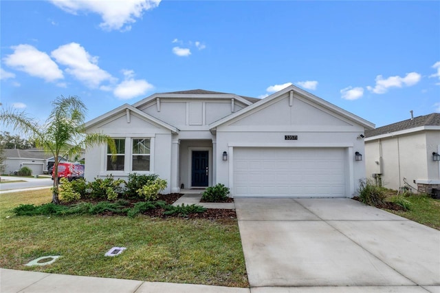 view of front of home featuring a front lawn and a garage