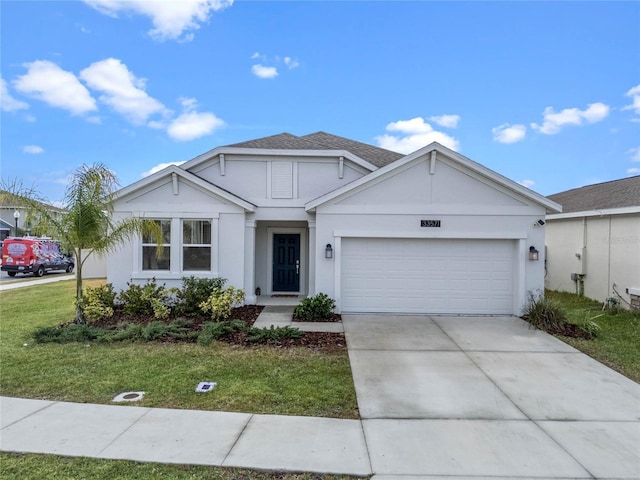 view of front of property featuring a garage and a front lawn