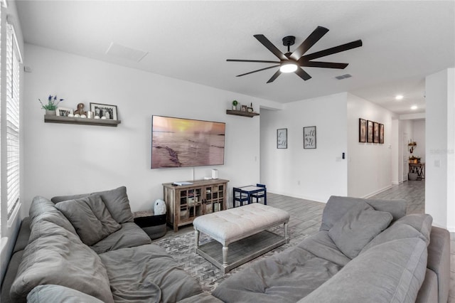 living room featuring ceiling fan and wood-type flooring