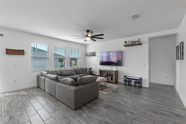 living room with hardwood / wood-style flooring and ceiling fan