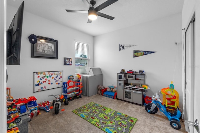 playroom featuring ceiling fan and carpet